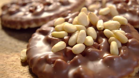 Cookies with peeled shelled pine nuts and milk chocolate. Food enjoyment concept. Macro