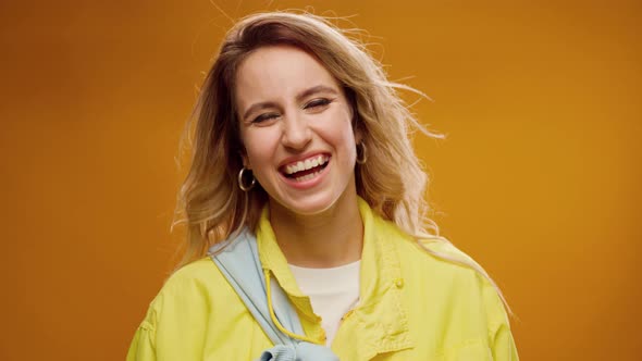 Happy Young Joyful Woman Portrait Smiling Against Yellow Background