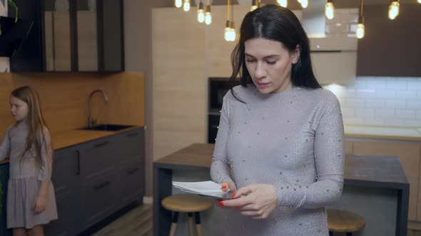 Portrait of Concentrated Caucasian Beautiful Woman Choosing Furniture Color in Shop with Blurred