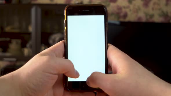 The Man Uses the Phone. Hands Is Typing on Smartphone with White Screen. Template.