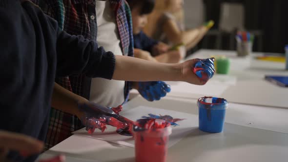 Diverse Children with Hands in Paint at Art Lesson