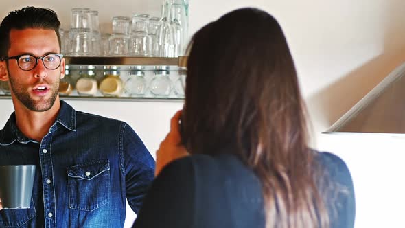 Couple interacting with eachother while having coffee