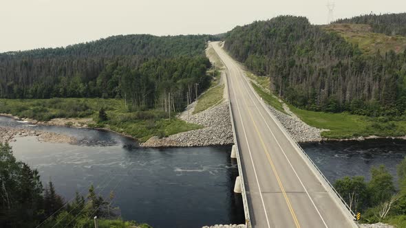 4K Salmon river going down view of bridge - Drone flying - road - top down