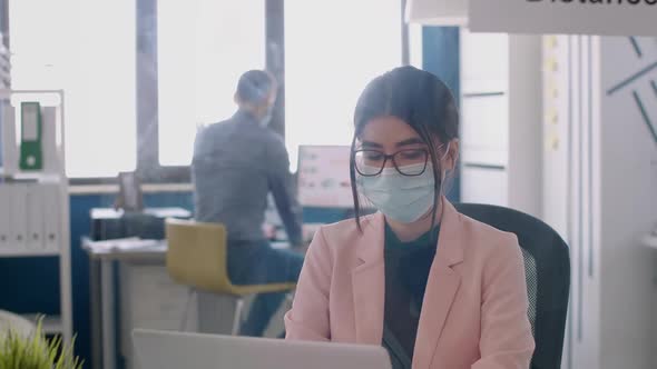 Portrait of Entrepreneur Working on Laptop Computer Analysing Financial Graphs