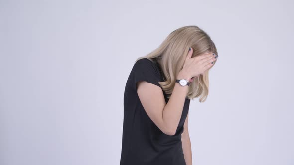 Young Stressed Blonde Woman Covering Eyes Not Wanting To See Something