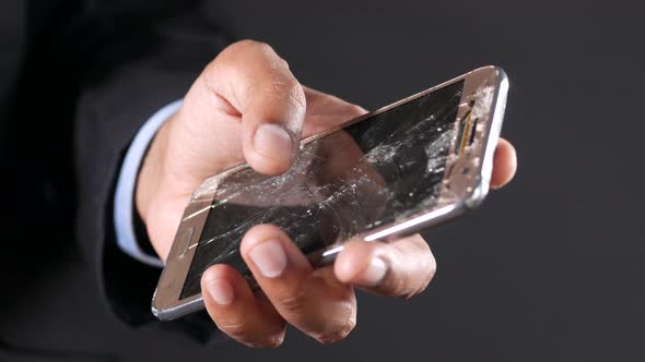 Close Up of Man Hand Holding Broken Smart Phone