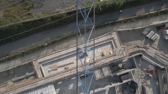 Top View Of A Tower Crane Structure Erected In A Construction Site. Assembly Of Steel Boom, Cabin, M