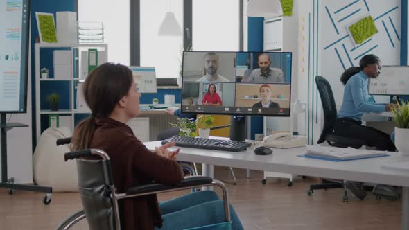 Paralysed Project Manager Talking with Team During Video Conference