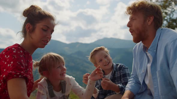 Family Have Fun Sitting Meadow at Summer Closeup