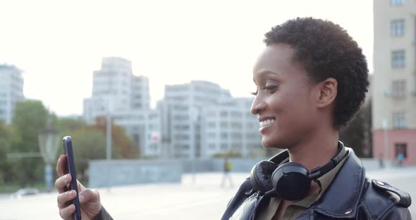 Young Teenage African Girl Chatting on Video Conference with Friends Using Smartphone Device