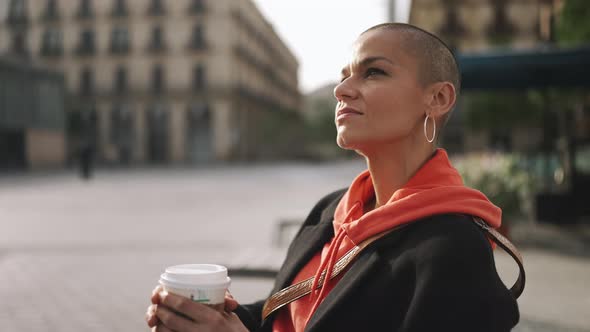 Pensive bald woman drinking coffee