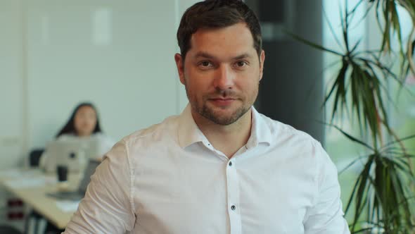 Close Up Portrait of Happy Handsome Young Male Employee Looking at Camera and Smiling in Modern