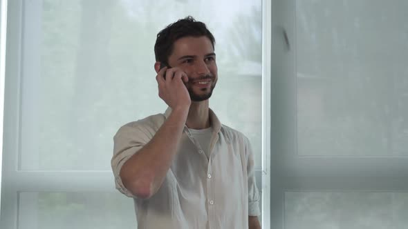 Portrait Happy Man Talking on the Smart Phone Indoor