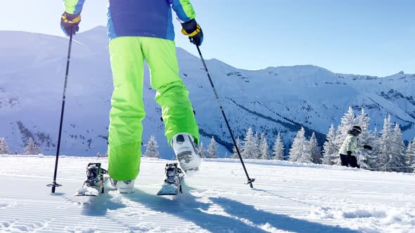 Boy Skier Puts on Ski View From Behind with Fresh Track Bellow