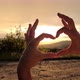 women's hands make a heart at sunset - VideoHive Item for Sale