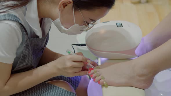 Cosmetologist Performs the Procedure Makes Brush Strokes Applies Red Varnish