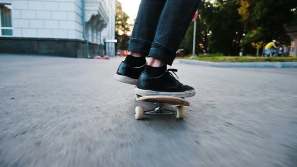 Man on a Skateboard Performs an Ollie Flip - Trick Kickflip Leap on a Board Across an Obstacle Close