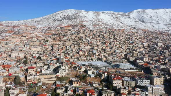 Hermon mountain ridge covered with snow during 2022 winter, with the town houses of Majd al Shams.