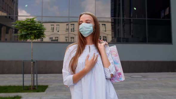 Teenager Girl with Multicolor Shopping Bags Wearing Protect Mask. Black Friday During Coronavirus