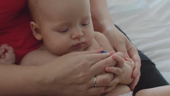 Mother Checking Her Baby Daughter's Temperature