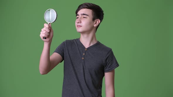 Young Handsome Iranian Teenage Boy Against Green Background