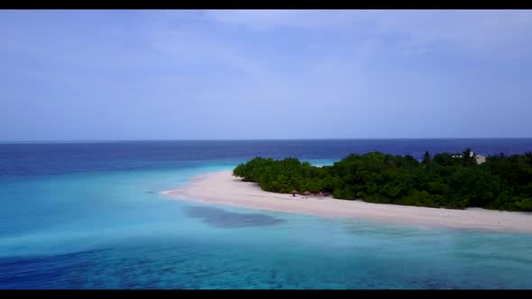 Aerial drone view seascape of idyllic resort beach voyage by blue ocean and white sandy background o