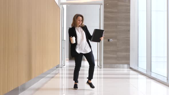 Funny Businesswoman Dancing In Wireless Earphones With Coffee Cup