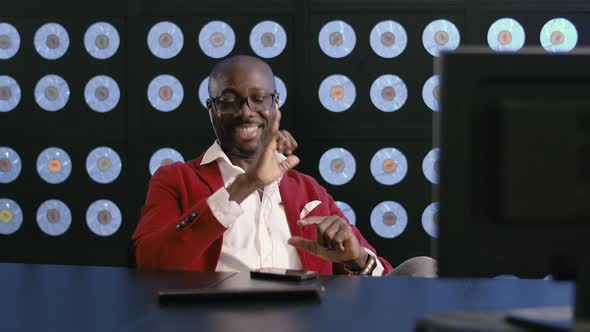 Africanamerican Man Listens to Music Sings Dances Sitting at Desktop