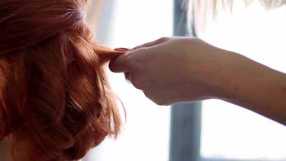 Professional Hairdresser Makes Hairstyle for Redhaired Woman