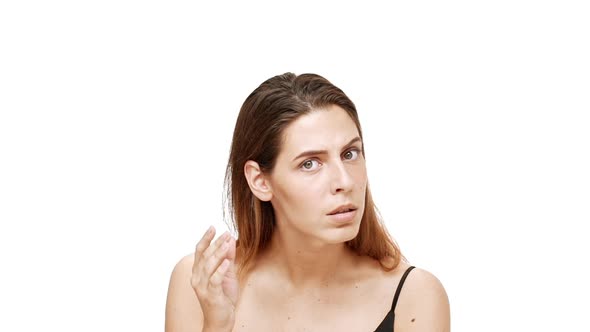 Displeased Young Beautiful Girl Listening Gesturing Over White Background