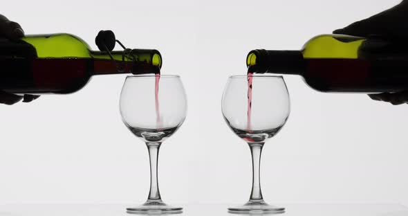 Rose Wine. Red Wine Pour in Two Wine Glasses Over White Background