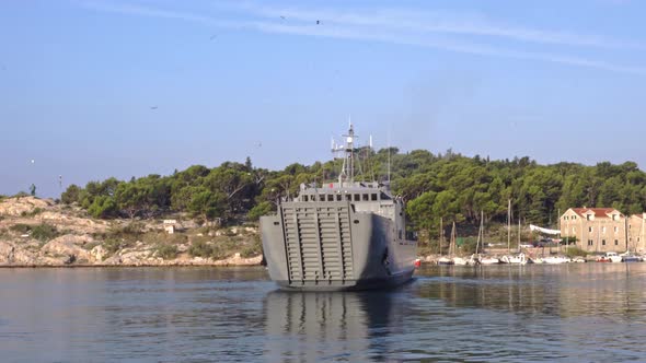 A Warship Leaves the Port in the Morning