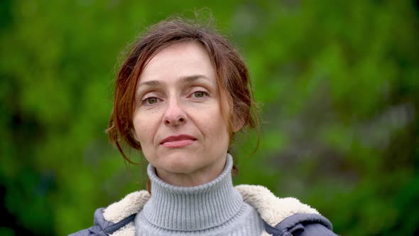 Closeup portrait of an adult beautiful woman outdoors