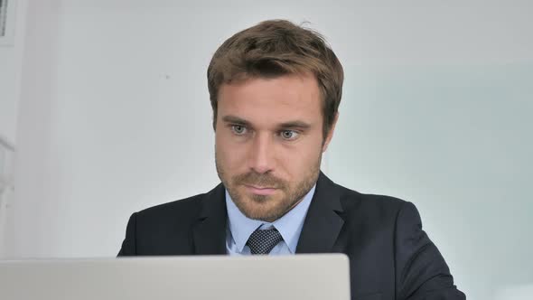 Close Up of Businessman Working On Laptop