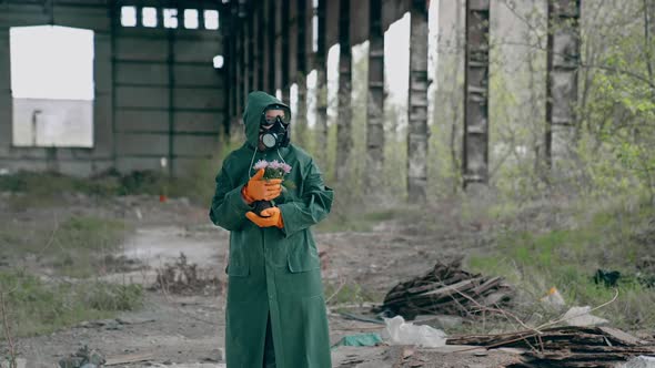 Post apocalyptic character with a gun standing in abandoned hangar