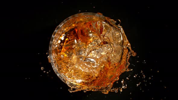 Super Slow Motion Shot of Ice Cube Falling Into Whiskey at 1000Fps