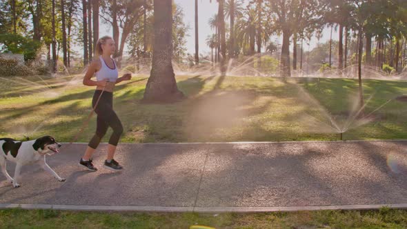 Attractive Woman Jogging With Her Dog