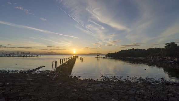 Timelapse sunrise over old dilapidated pier