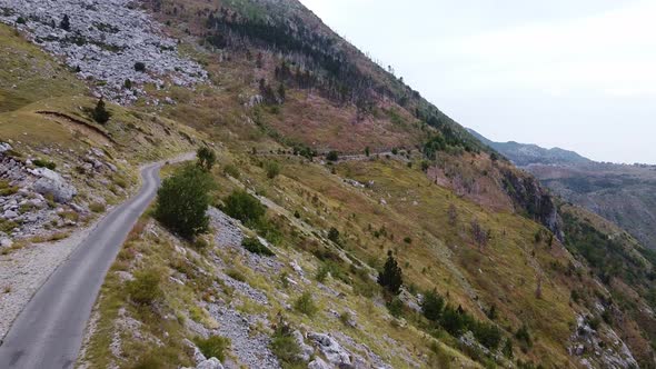 Flight Near a Winding Road High in the Mountains