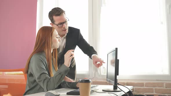 Office Worker Shows His Result To the Director They Look at Computer Screen