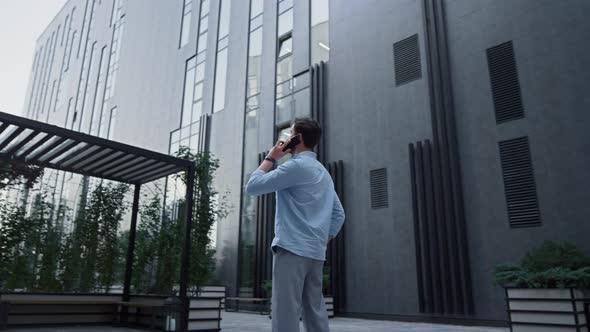 Handsome Man Standing Typing Mobile Phone at Office District