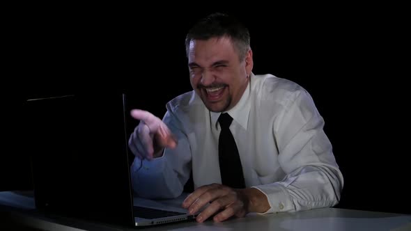 Young Man Laughing at a Funny Video From the Internet