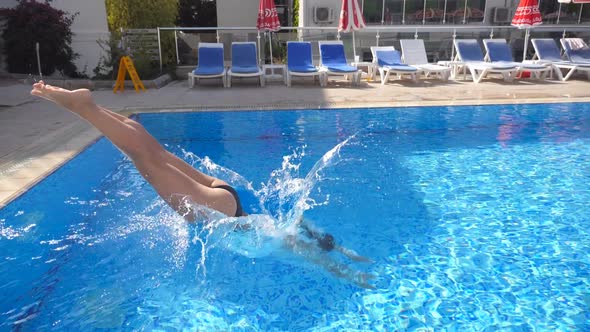 Young Beautiful Woman Jumping in Basin and Then Emerges From Under the Water