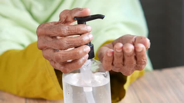 Close Up of Senior Women Hand Using Sanitizer Gel for Preventing Virus