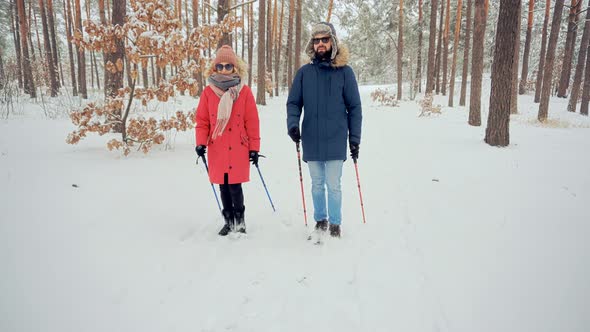 Hiker Practicing Nordic Walking In Forest. Sticks Walking On Winter Forest. Hiker Hiking Sport.