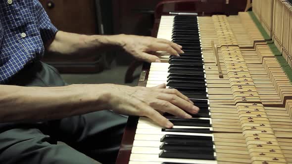 Piano Workshop, A Senior Man tuning an Old Piano.