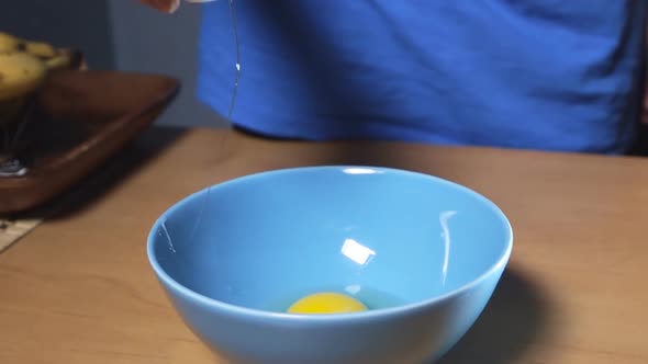 Hand Breaking Egg For Cooking