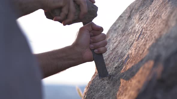 Ancient Man Cave Painting and Writing Historic Inscription Graffiti on Rock Surface With Iron Chisel