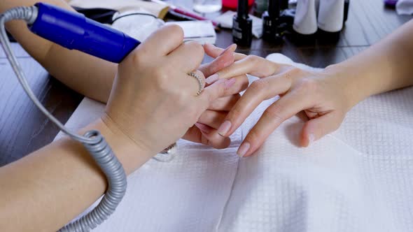 Manicurist Removing Cuticle.