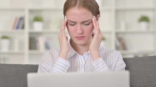 Portrait of Young Woman with Laptop Having Headache 